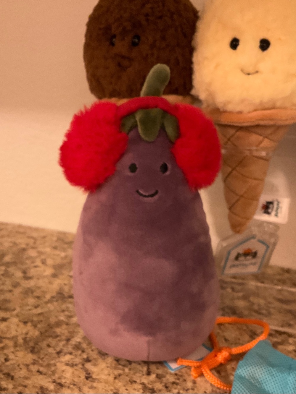 Jellycat Toastie Eggplant Plush with Red Pom Earmuffs